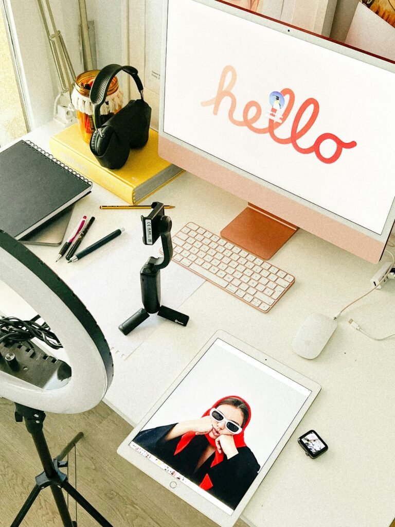 Stylish workspace featuring tech gadgets and 'Hello' screen art in elegant design.